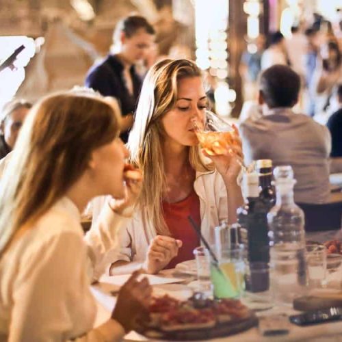Gasten genieten samen van eten en drinken
